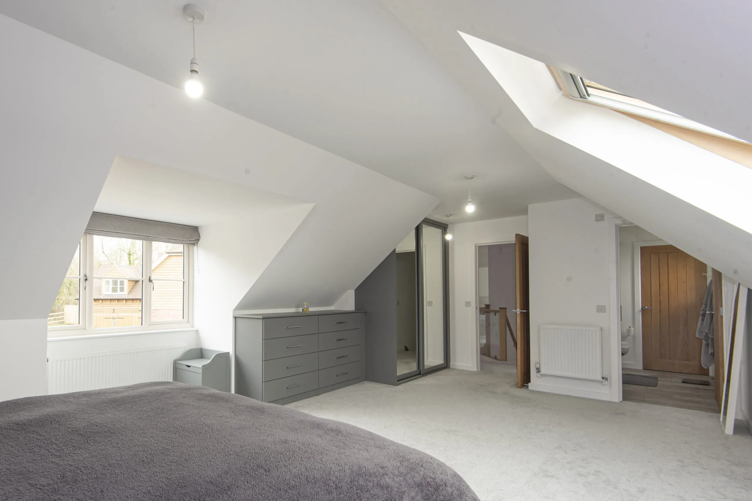 Loft conversion bedroom with handmade sliding wardrobes and chest of drawers