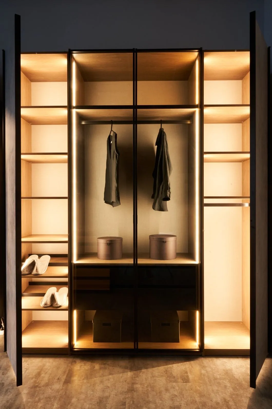 Planning a Walk-in Wardrobe: An empty walk-in wardrobe in a dark room, with bright storage lighting
