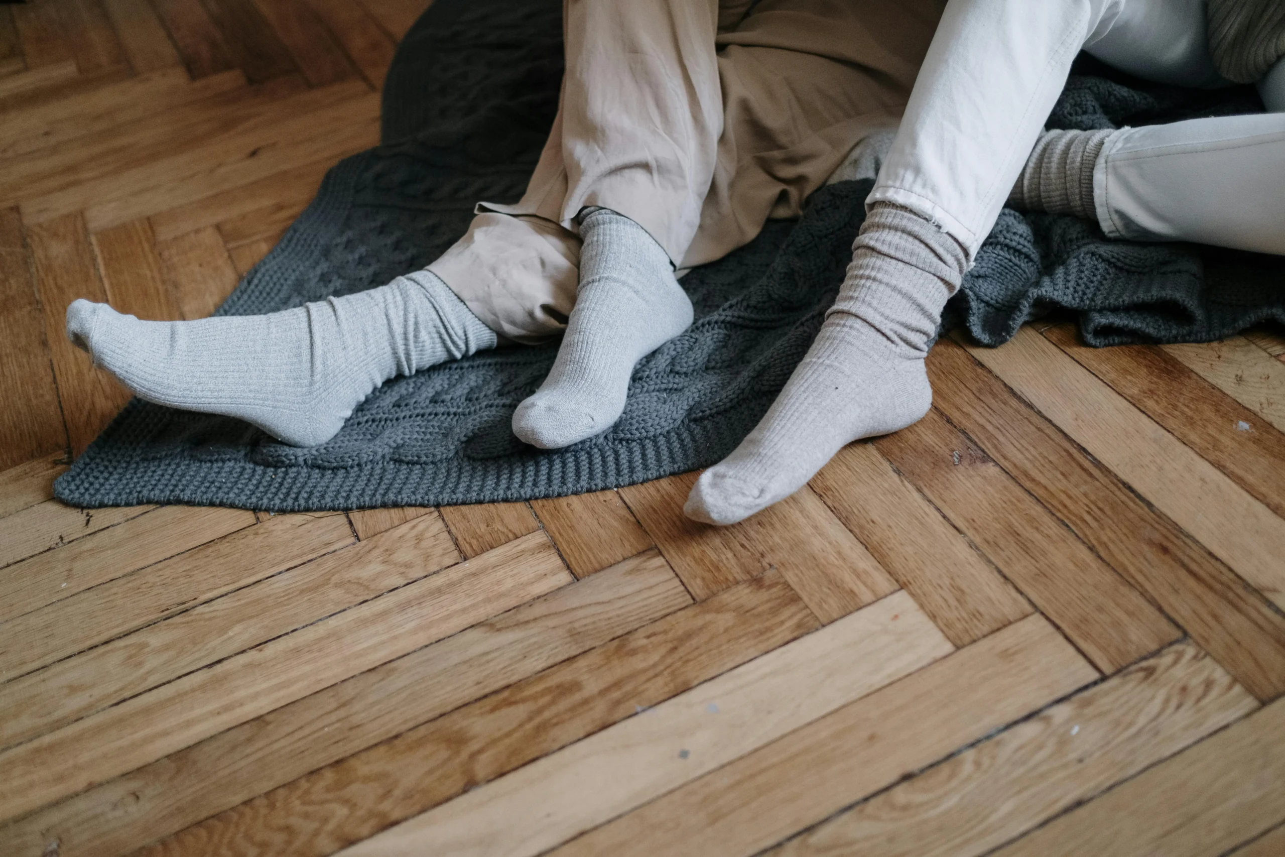 Adding Value to Your Home: A couple sat on wooden floorboards